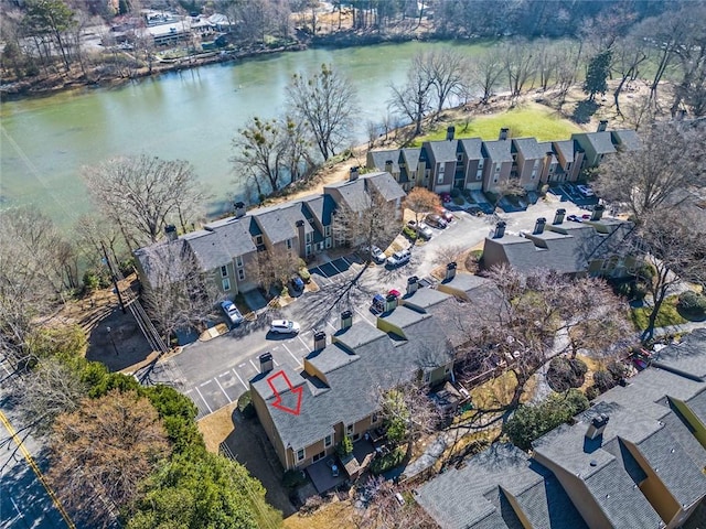 drone / aerial view featuring a water view and a residential view