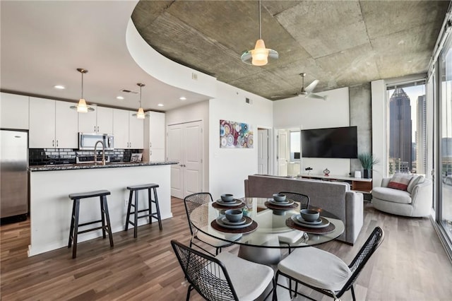 dining room with hardwood / wood-style flooring and ceiling fan