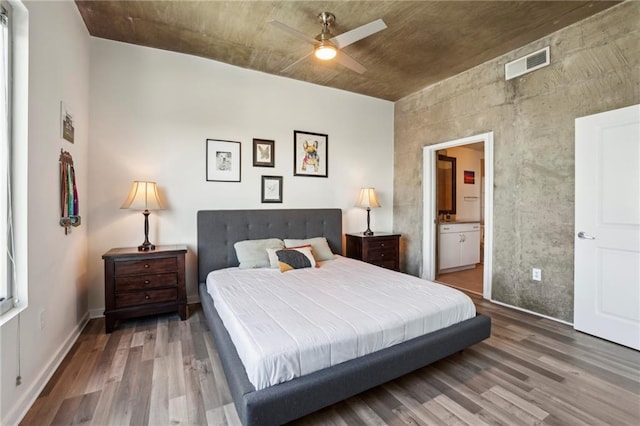 bedroom featuring connected bathroom, hardwood / wood-style floors, and ceiling fan