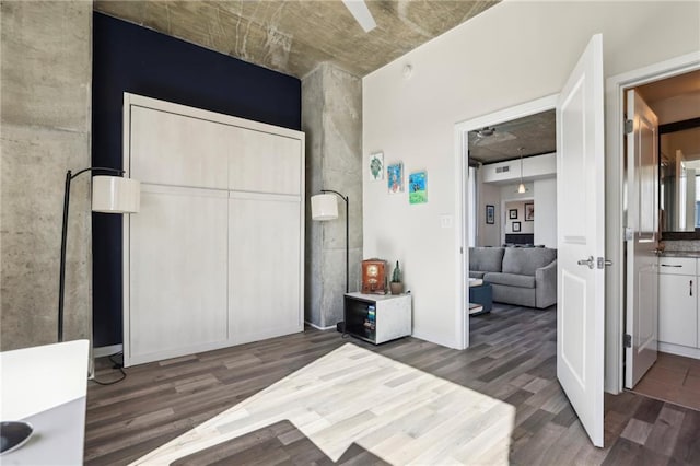 unfurnished bedroom featuring dark wood-type flooring and a closet