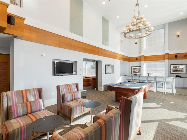 recreation room with a high ceiling, billiards, a chandelier, and carpet