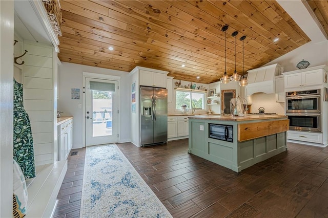 kitchen with stainless steel appliances, wood ceiling, lofted ceiling, white cabinetry, and pendant lighting