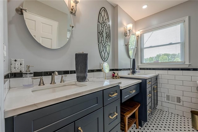 bathroom featuring tile walls and vanity