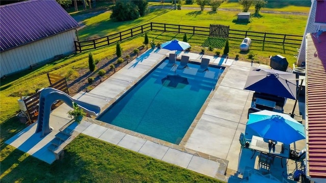 view of pool with a water slide and a patio area