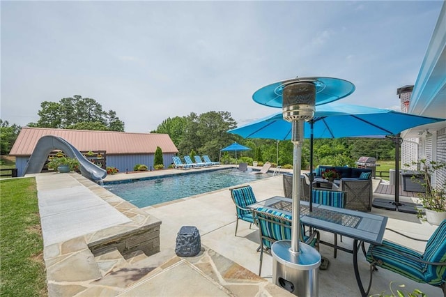 outdoor pool featuring a patio and a water slide