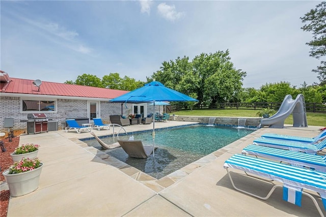 outdoor pool with a grill, a water slide, a patio area, and an outdoor living space