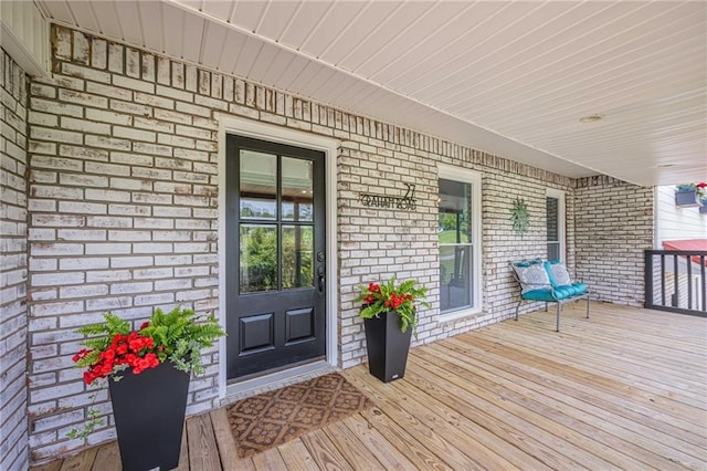 wooden terrace featuring covered porch