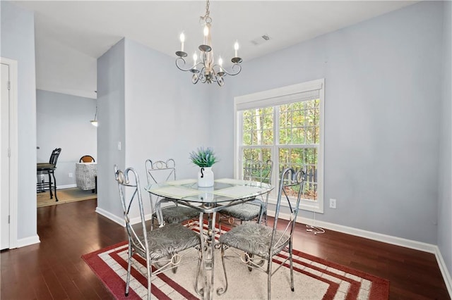 dining room featuring a notable chandelier and dark hardwood / wood-style flooring