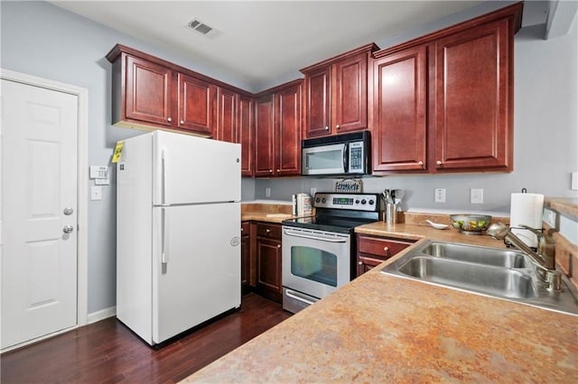 kitchen featuring appliances with stainless steel finishes, dark hardwood / wood-style floors, and sink