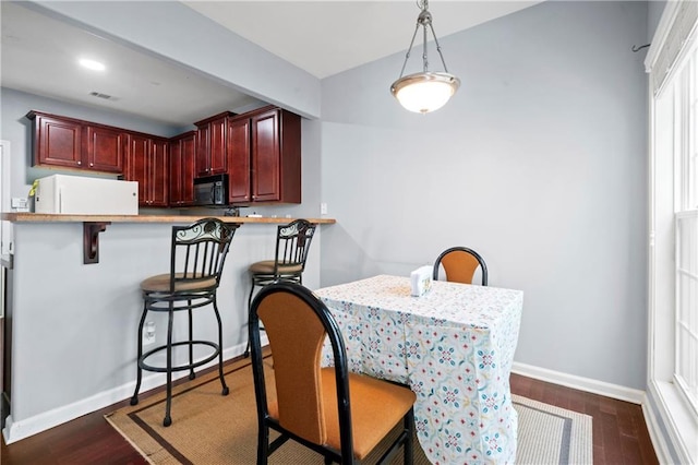 dining space with dark hardwood / wood-style floors