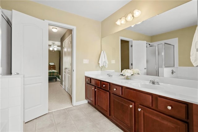 bathroom featuring vanity, a shower with shower door, tile patterned floors, and ceiling fan