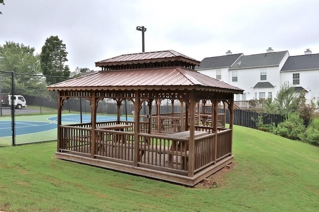 wooden terrace featuring a gazebo, basketball court, and a lawn