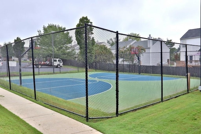 view of sport court featuring a yard