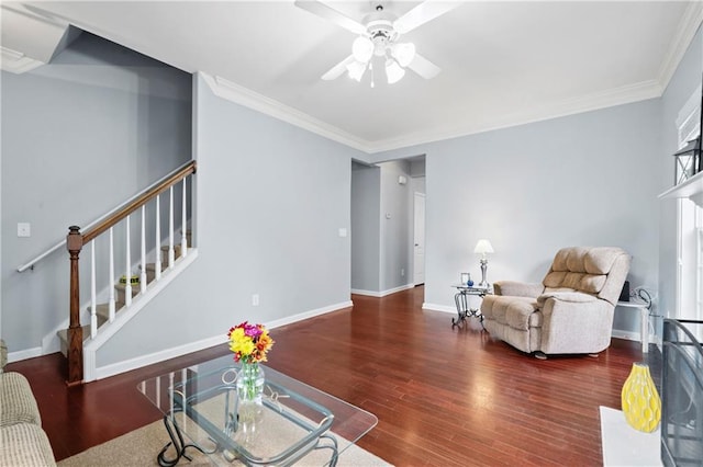 living room with hardwood / wood-style floors, crown molding, and ceiling fan