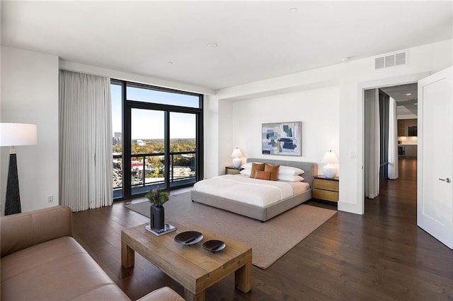 bedroom with access to exterior and dark wood-type flooring