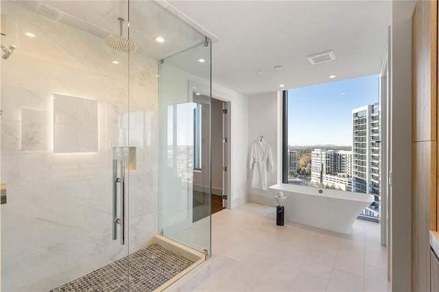 bathroom featuring plus walk in shower and tile patterned floors