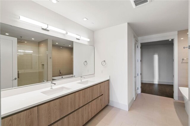 bathroom featuring tile patterned floors, vanity, and separate shower and tub