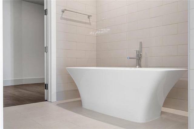 bathroom with hardwood / wood-style floors and a bathtub