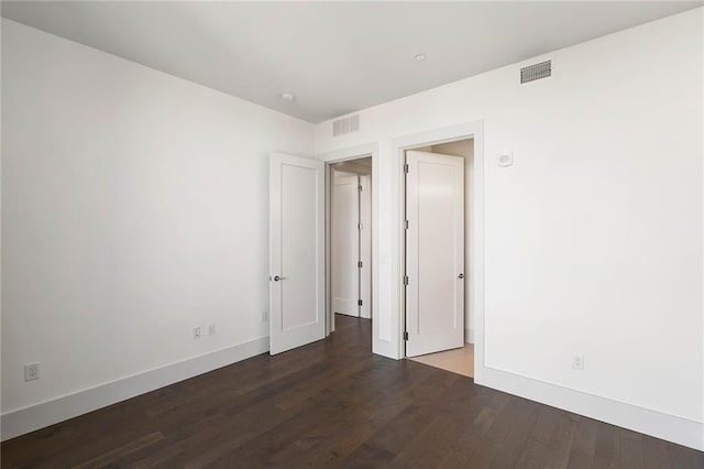 unfurnished bedroom with dark hardwood / wood-style flooring