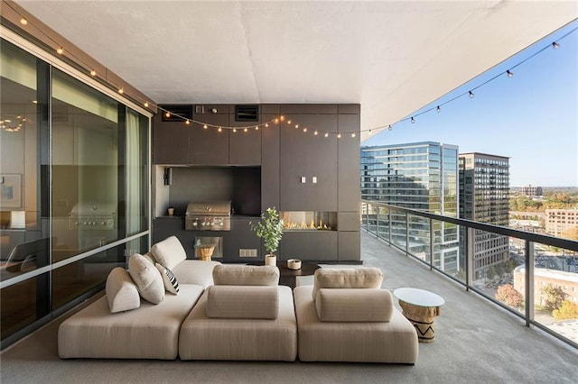 balcony with an outdoor living space and area for grilling