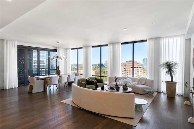 living room featuring a chandelier, expansive windows, and dark wood-type flooring