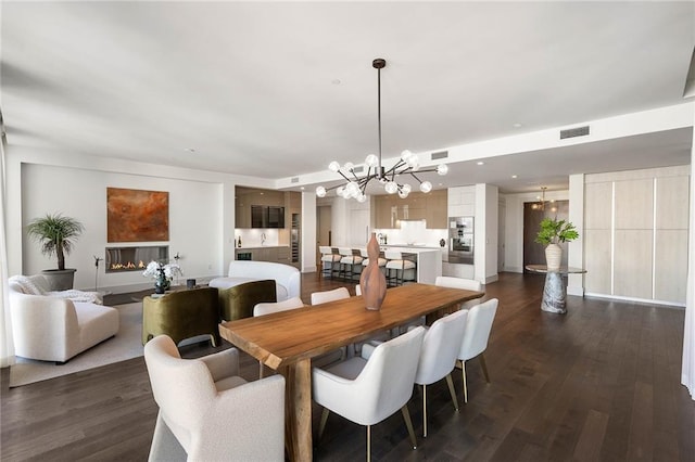 dining room featuring an inviting chandelier and dark wood-type flooring