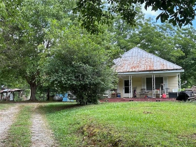 view of front of home featuring a front yard and a porch