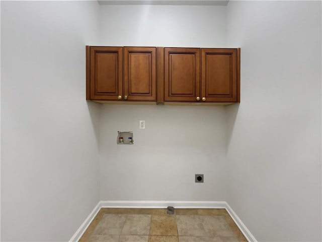 clothes washing area featuring electric dryer hookup, baseboards, cabinet space, and hookup for a washing machine