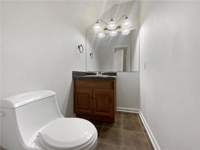 bathroom featuring baseboards, toilet, vanity, and tile patterned flooring