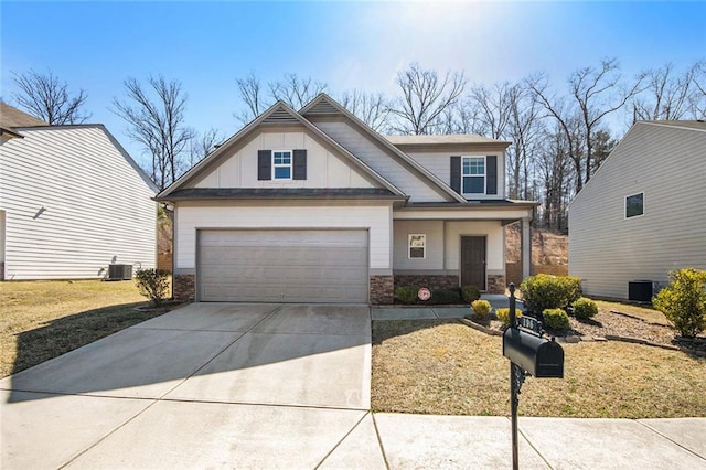 craftsman house featuring driveway, board and batten siding, stone siding, and cooling unit