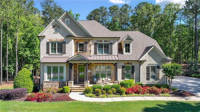 5330 Lake Redwine Cv NW, Acworth, GA 30101 - craftsman-style house with a porch, a front lawn, stone siding, a standing seam roof, and a shingled roof