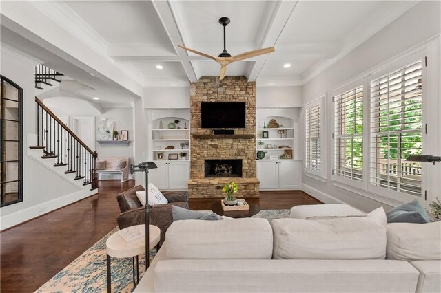 5330 Lake Redwine Cv NW, Acworth, GA 30101 - living room with dark wood-style flooring, baseboards, a stone fireplace, a ceiling fan, and crown molding