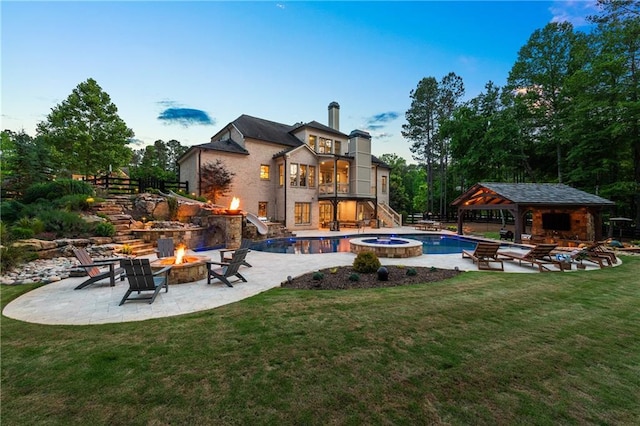 5330 Lake Redwine Cv NW, Acworth, GA 30101 - back of property with a fire pit, stairway, a gazebo, and a lawn