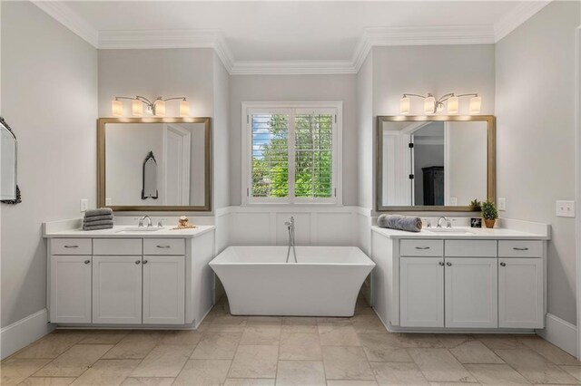 5330 Lake Redwine Cv NW, Acworth, GA 30101 - full bathroom with ornamental molding, a wainscoted wall, two vanities, a freestanding bath, and marble look tiles