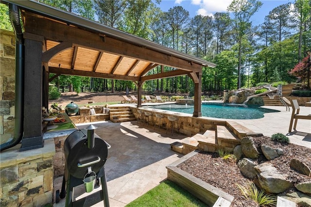 5330 Lake Redwine Cv NW, Acworth, GA 30101 - swimming pool featuring a patio area, a gazebo, a water slide, and view of scattered trees