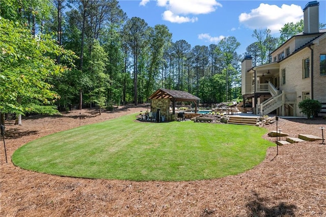 5330 Lake Redwine Cv NW, Acworth, GA 30101 - view of grassy yard with stairs, a gazebo, and a ceiling fan