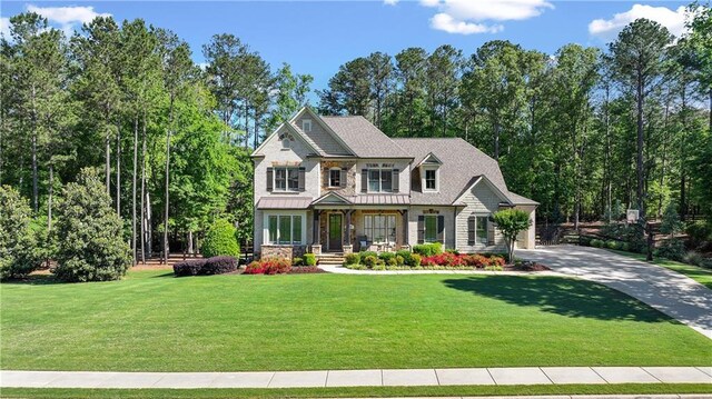 5330 Lake Redwine Cv NW, Acworth, GA 30101 - craftsman-style house featuring a porch, a front yard, stone siding, driveway, and a standing seam roof