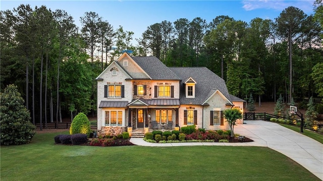 5330 Lake Redwine Cv NW, Acworth, GA 30101 - craftsman-style home featuring a porch, driveway, stone siding, and a standing seam roof