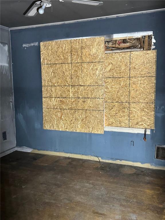spare room with baseboards