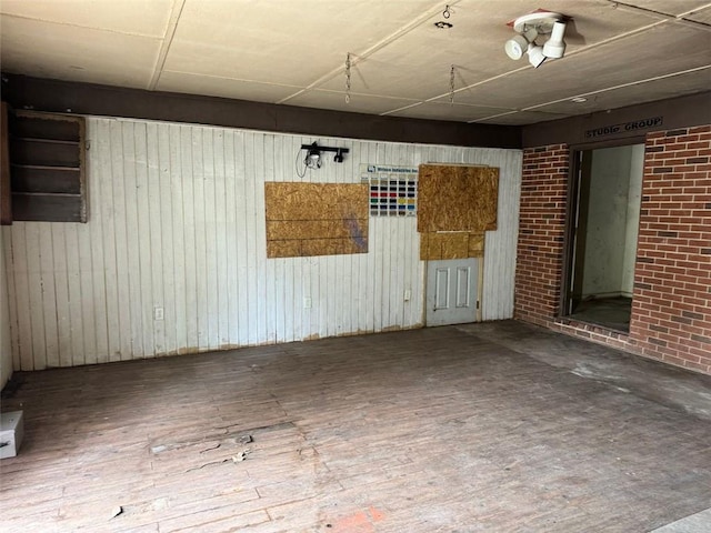 spare room featuring wooden walls and hardwood / wood-style flooring