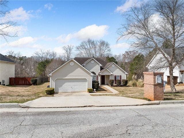 view of front of property with a front yard, driveway, an attached garage, and fence