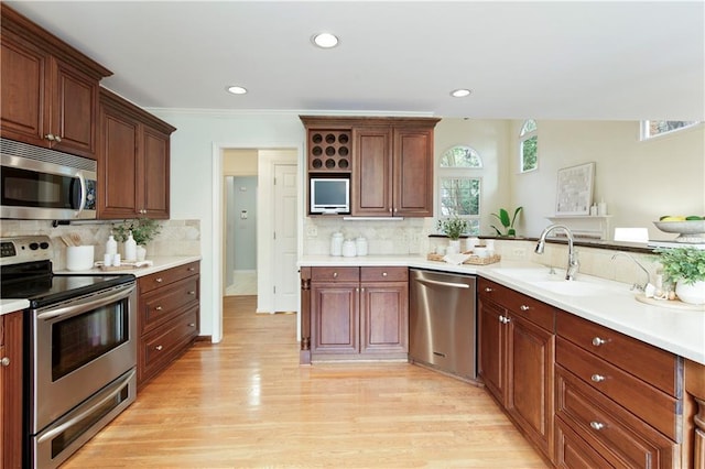 3711 Spinnaker Cir, Alpharetta, GA 30005 - kitchen with stainless steel appliances, light wood-style flooring, a sink, decorative backsplash, and recessed lighting