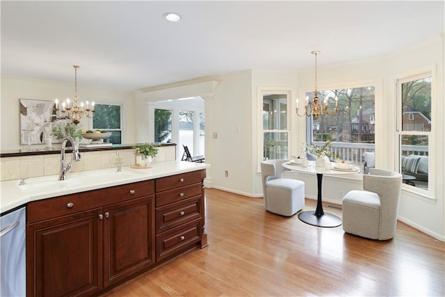 3711 Spinnaker Cir, Alpharetta, GA 30005 - kitchen featuring a chandelier, a sink, stainless steel dishwasher, light wood-style floors, and crown molding