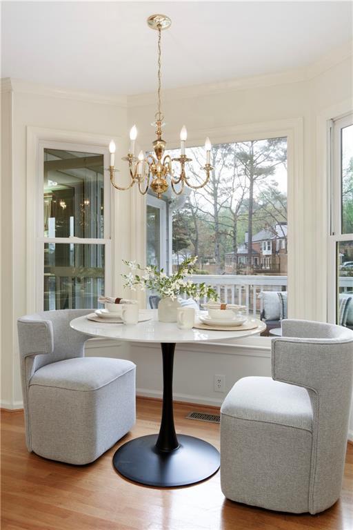 3711 Spinnaker Cir, Alpharetta, GA 30005 - dining room with a chandelier, wood finished floors, and ornamental molding