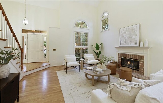3711 Spinnaker Cir, Alpharetta, GA 30005 - living area with a towering ceiling, stairs, light wood-style floors, baseboards, and a chandelier