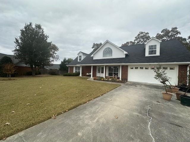 cape cod house with a front yard, concrete driveway, brick siding, and an attached garage