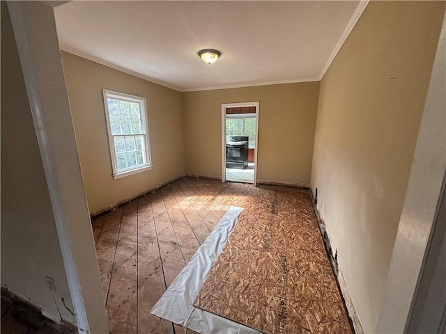 spare room with ornamental molding and wood-type flooring