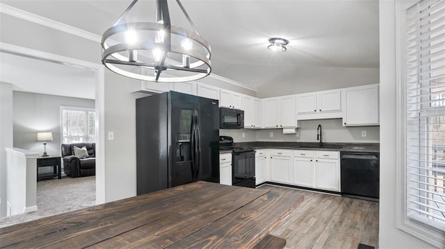 kitchen featuring black appliances, a sink, dark countertops, an inviting chandelier, and white cabinets