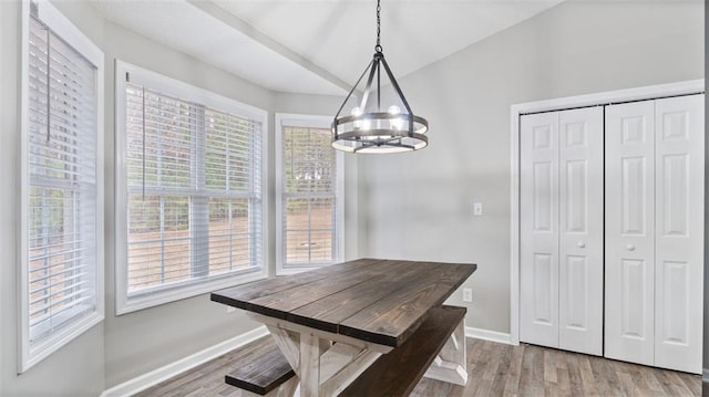 dining room featuring baseboards, a notable chandelier, and wood finished floors