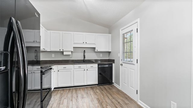 266 Carthage Blvd, Rockmart, GA 30153 - kitchen featuring black appliances, a sink, lofted ceiling, light wood-type flooring, and white cabinets